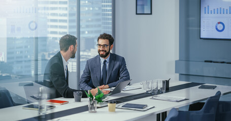 Wall Mural - Businesspeople in Modern Office: Business Meeting of Two Businessmen Talking. CEO and Executive Strategy Brainstorming Ideas for Digital e-Commerce Software Investment. Handsome Happy Professionals