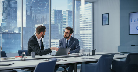 Leinwandbilder - Businesspeople in Office: Business Meeting of Two Businessmen Using Laptop Computer and Talking. Tech CEO and Executive Director do Brainstorming for Digital e-Commerce Software Investment Solution