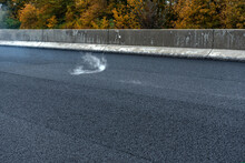 Laying A New Asphalt On The Road. Smoke On Tne New Asphalt. Construction Of The Road.