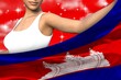 beautiful girl holds Cambodia flag in front on the red colorful clouds - flag concept 3d illustration