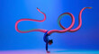 Leinwandbild Motiv Young girl, flexible gymnast doing sport excercise isolated on blue background in neon light. Contemporary art collage. Illusion.