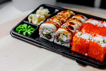 Wall Mural - Japanese sushi food. Maki ands rolls with tuna, salmon, shrimp, crab and avocado. Top view of assorted sushi. Rainbow sushi roll, uramaki, hosomaki and nigiri.