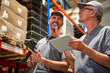 © gpointstudio - Two caucasian men in mature age discussing together in warehouse