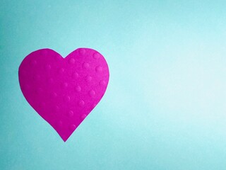 Wall Mural - pink heart on green background  with texture dots on heart with copy space