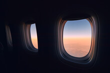 Windows Of Airplane During Flight Above Clouods At Beautiful Sunrise. .
