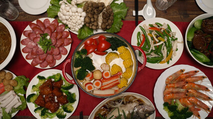 Wall Mural - view from above delicious Chinese traditional dishes served on dinner table prepared for celebrating the chinese new year