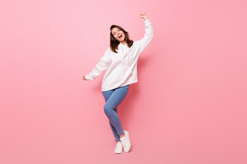 Wall Mural - Full length photo of joyful happy young woman dance funky good mood isolated on pastel pink color background
