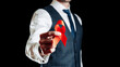 © Maksym - Aids awareness. Red ribbon symbol in hiv world day in man hand isolated on dark background. Awareness aids and cancer. Healthcare and medical concept.