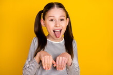 Photo Of Young Girl Happy Positive Smile Grimace Tongue-out Hold Hands Dog Isolated Over Yellow Color Background