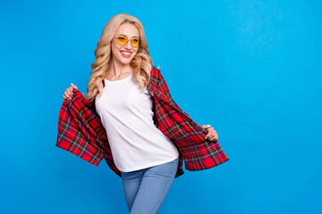 Sticker - Photo of funky sweet woman dressed checkered shirt dark glasses dancing empty space smiling isolated blue color background