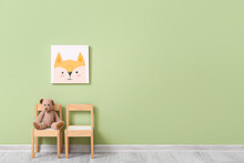 Wooden Chairs With Cute Bear Toy And Painting On Color Wall In Child Room