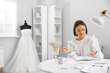 Wall Mural - Female wedding planner working in office