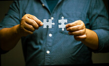 Man Hand Connecting Jigsaw Puzzle. Business Solutions And Success Concept. Network, Strategy And Teamwork.