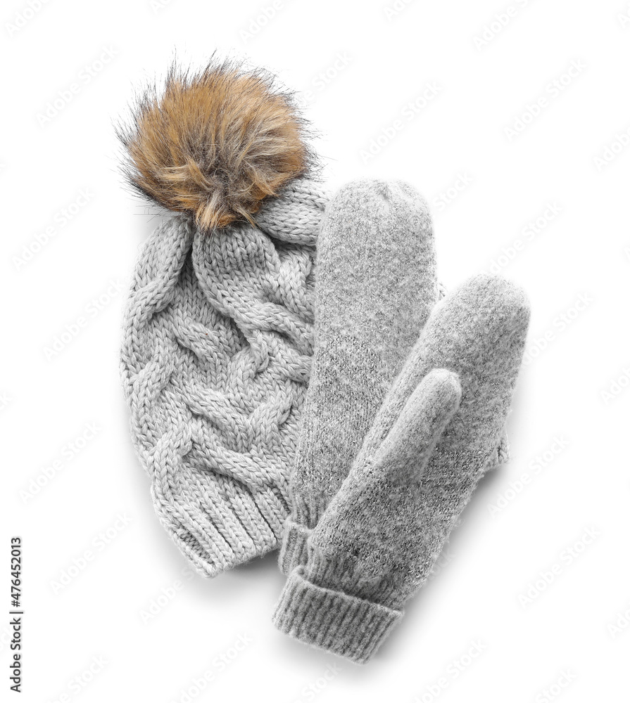 Warm hat and mittens on white background