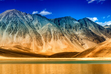 Beautiful Mountains And Pangong Tso (Lake). It Is A Huge Lake In Ladakh, Extends From India To Tibet. Leh, Ladakh, Jammu And Kashmir, India. Himalayan Mountains In Background. Colourful Stock Image.