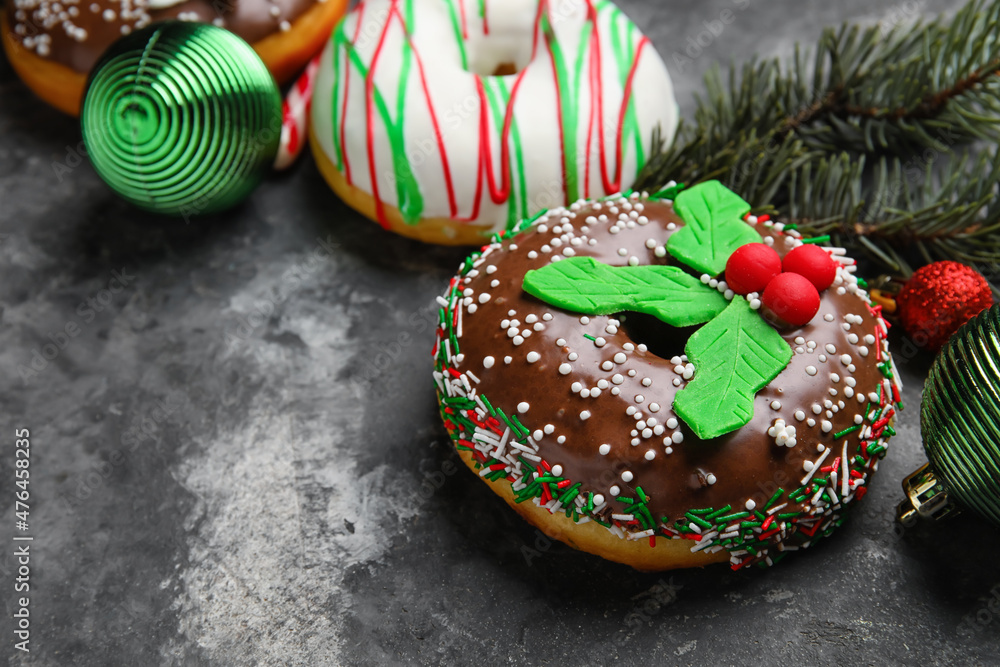 Tasty Christmas donuts on grey background, closeup