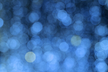 abstract bokeh lights in blue. defocused background. blurred bright light. circular points.