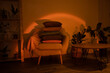 © oksix - Home interiour, cozy chair with pillows at sunset