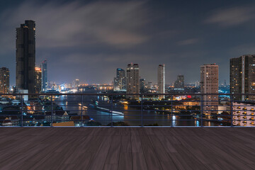 Wall Mural - Panoramic Bangkok skyline view, wooden observatory deck on rooftop, night time. Asian corporate and residential lifestyle. Financial city downtown, real estate. Product display mockup empty roof