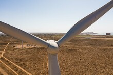 Aerial View Of A Wind Power Generator In A Desert Valley  Desert Blades Of A Wind Turbine In Electric Energy, Electric Generator Moved By A Turbine Driven By The Wind, Blades, Horizon, 