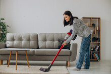 Woman Doing House Work With Rechargeable Vacuum Cleaner