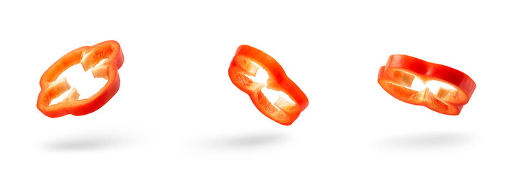 Set of slices of red pepper drops on a white background. Paprika flying in air on isolated white background