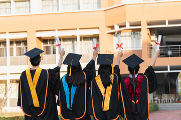 Wall Mural - graduates wearing black hats holding university graduation certificates,Concept education congratulation. Graduation Ceremony ,Congratulated the graduates in University.
