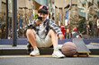 © imtmphoto - teenage asian child resting relaxing looking at cellphone on street