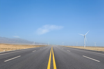 Canvas Print - road through a wind farm