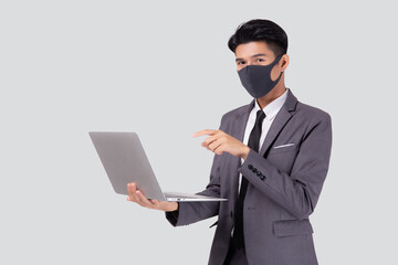 Wall Mural - Young asian business man in face mask using laptop computer isolated on white background, quarantine and epidemic covid-19, businessman work from home for health, social distancing, new normal.