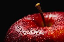 Red Apple With Water Drops Close Up On Dark Background