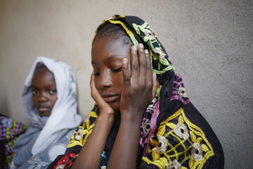 Two black African girls with a sad and worried expression on their faces anticipating an uncertain fate; gender equity, gender disadvantage concept