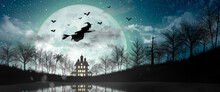 Halloween Silhouette Of Witch Flying Over The Full Moon.