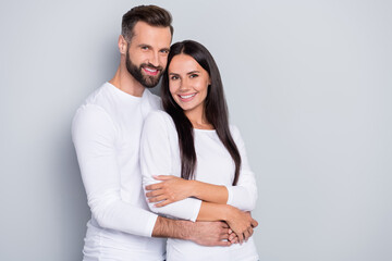 Wall Mural - Photo of cute young couple embrace wear white shirt isolated on grey color background