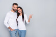 © deagreez - Photo of cute millennial couple indicate promo wear white shirt isolated on grey color background