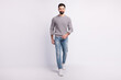 © Tetiana - Full size photo of young guy confident go walk wear casual clothes isolated over grey color background