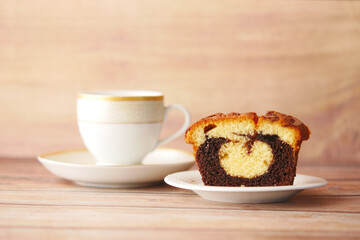 slice of bakery chocolate cake and tea on table 