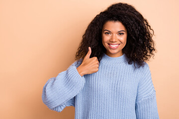 Sticker - Photo of young cheerful girl show thumb-up approve great ads select isolated over beige color background