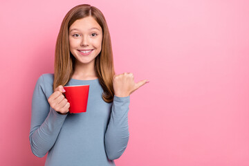 Poster - Portrait of attractive trendy cheerful funny girl drinking coffee showing copy space isolated over pink pastel color background