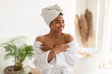 Wall Mural - Attractive African American Female Posing Wearing White Bathrobe In Bathroom