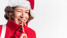 Curly Winking Woman With Striped Candy Cane. Pretty Female With Christmas Licorice Whip. Banner With Copy Space.