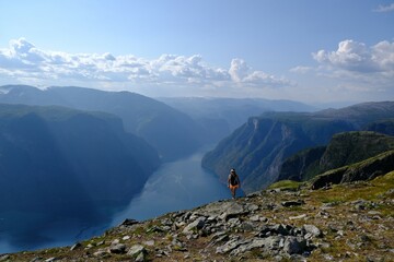 amazing scenery of aurlandsfjord from top of priest røyrgrind. blurry silhouette of a woman in motio
