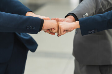 Group of businessmen pushing their fists for business cooperation, concept, business social connection. Working with a working team, contacting the business