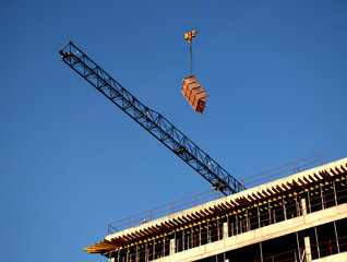 Crane above the building in the blue sky