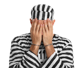 Wall Mural - Remorseful prisoner in striped uniform with handcuffs hiding his face on white background