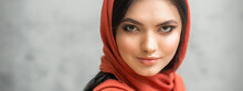 Portrait Of A Pretty Young Caucasian Woman With Makeup In A Red Headscarf On Gray Background