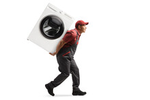 Full Length Profile Shot Of A Worker In A Uniform Carrying A Washing Machine On His Back