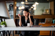 © David - Shot of Asian young businesswoman looking stressed while sitting in her office in front of the laptop.