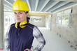 attractive woman worker with protective ear headphones