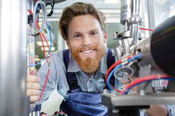 self portrait of attractive joyful man holding cables